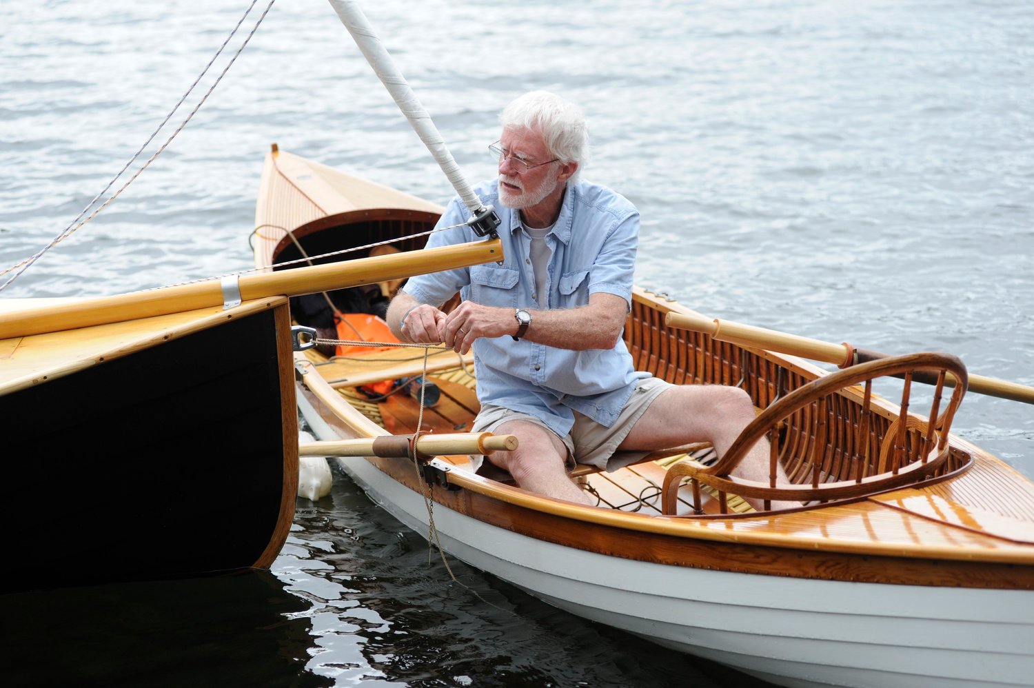 Making fast. Bruce Bidwell, a noted builder and restorer of wooden watercraft, ties up alongside Morse’s Narwhal. He is pictured in his meticulously restored 1900 Rushton pulling boat...